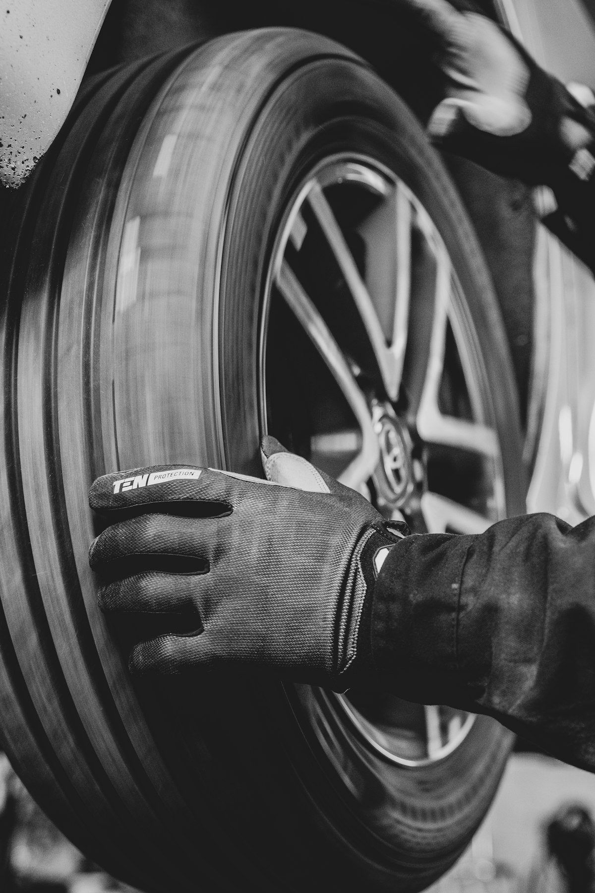 Technician inspecting a tire tread in the shop